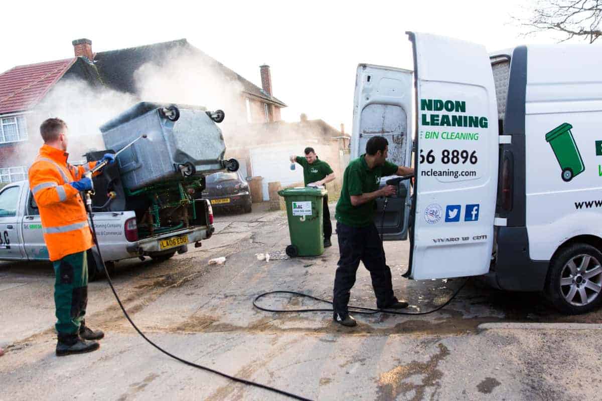 A group of men performing exterior cleaning on a van in front of a house. Passover,