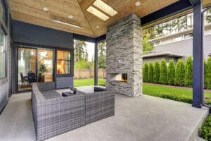 A modern outdoor living area with a fireplace, enhanced by commercial cleaning services for the roof and exterior.