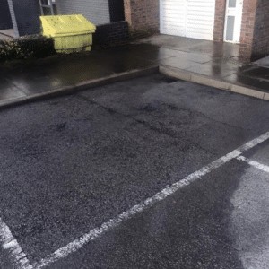 Tarmac Car Park Cleaning, A parking lot with a white line on it, undergoing exterior cleaning.