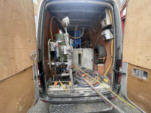 The back of a van with hoses for Exterior Cleaning.