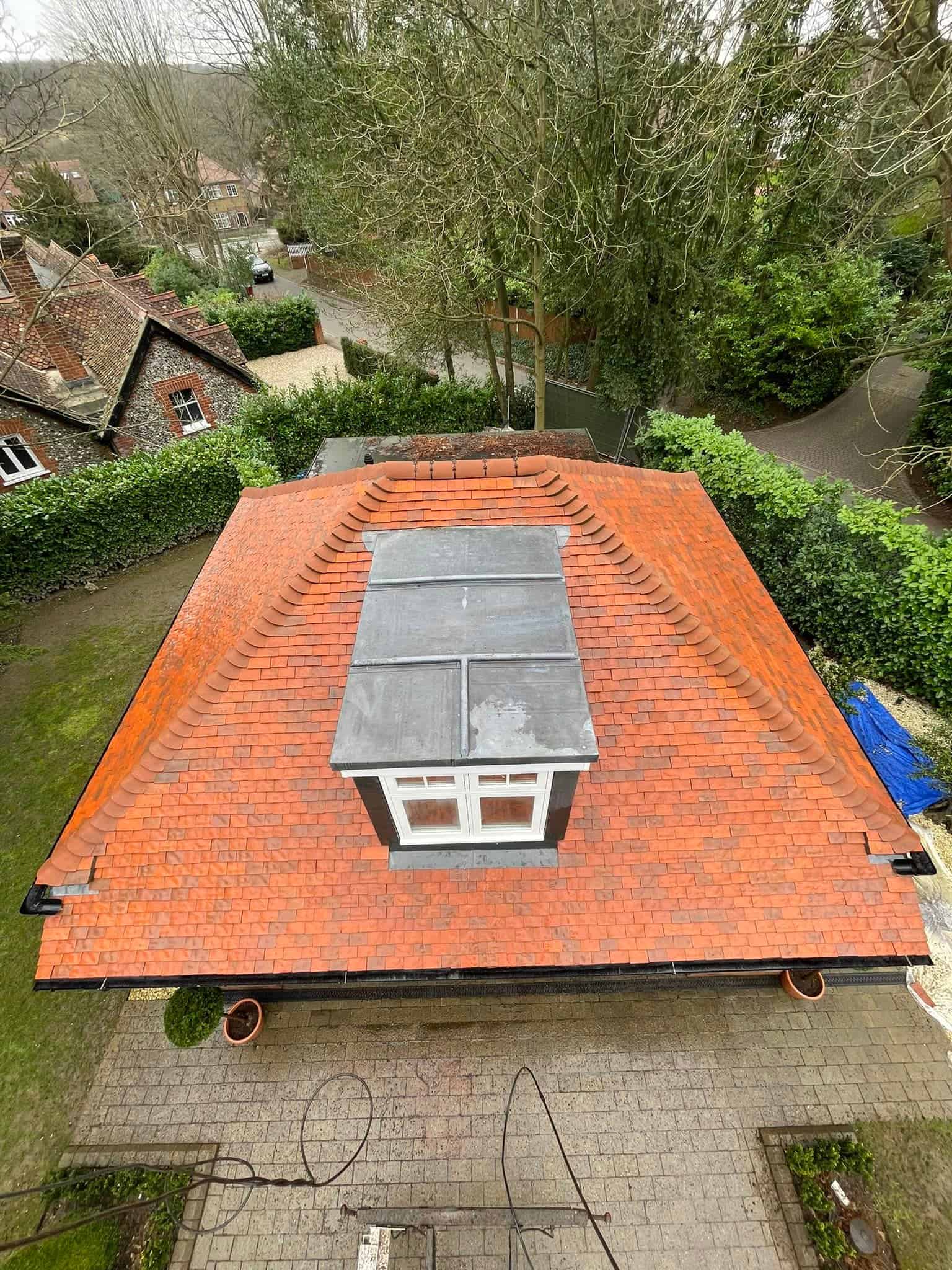 An aerial view of a roof being cleaned in London.